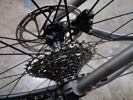 product #1588NS – Titanium All-Road | Purple Logo / Drop Bars / Rival eTap / 700x38c (Size Large, Used-Very Good Condition)