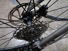 #1588NS – Titanium All-Road | Purple Logo / Drop Bars / Rival eTap / 700x38c (Size Large, Used-Very Good Condition)