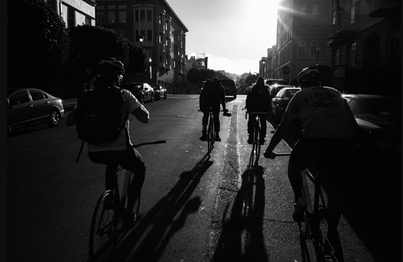 Group of riders pedaling into the afternoon sun 