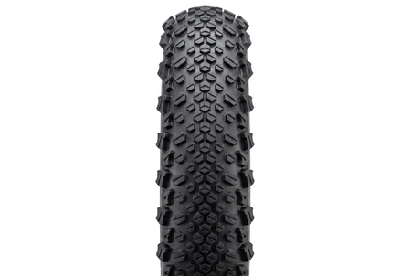product Close-up of a black tire with tread pattern on a white background